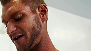 Black and white gay studs engage in intense anal oil fisting