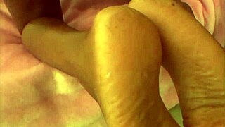 Feeling intense pleasure from ebony toes rubbing white cock to facial climax.