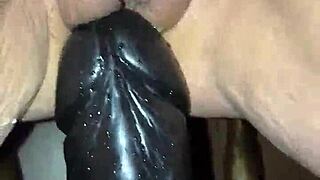 She takes the big dildo deep, fucking herself hard with toys in a casual scene.