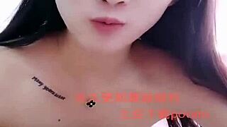 I watch this Asian amateur girl perform a strip show.