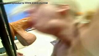 The blonde practices deep throating with a large dildo.