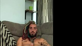 Dreddy emo punk dude strokes tattooed cock intriguingly