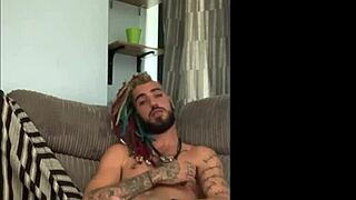 Dreddy emo punk dude strokes tattooed cock intriguingly