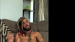 Dreddy emo punk dude strokes tattooed cock intriguingly