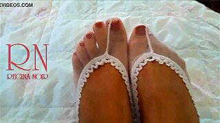 Cute chick lies on bed in white socks and bends gracefully