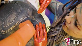 two latex dominatrixes dominate sissy with anal fisting in bdsm scene