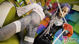 two latex dominatrixes dominate sissy with anal fisting in bdsm scene