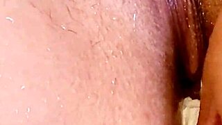 Shaved woman in shower with ass plug