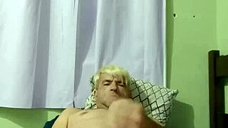 Young gay boy engages in intense sex with his partner on the bed.