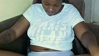 Look at this black babe teasing her pussy with big tits