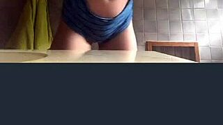 A blonde girl records herself in the bathroom