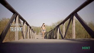 Petite and beautiful talia mint relaxes on the public beach