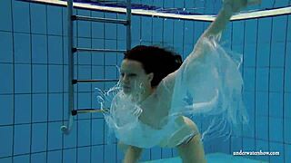 Kristy, a stunning brunette, flaunts her curves in the pool