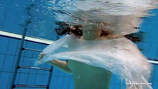 Kristy, a stunning brunette, flaunts her curves in the pool