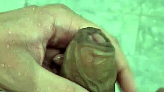 Well-endowed young man plays in the shower