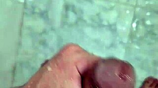 Well-endowed young man plays in the shower