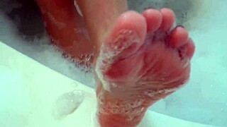 A brunette with big natural tits shows off her tight body and feet in a casual display