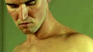 Angry gay hunk strokes cock and cums on sofa