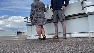 Milf spreads legs wide and bends over in parking lot