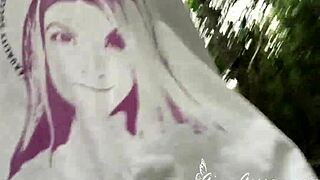 Two blonde lesbians flash each other in public outdoors.