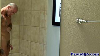 Muscular inked guys engage in interracial gay sex in the shower