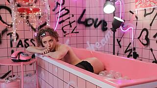 Anita relaxes in pink trash bath