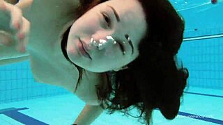 Katy's bushy pussy shines in red swimsuit underwater