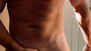 bodybuilder gets horny while pissing in bathroom