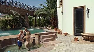 Blonde Babe Bent Over in Doggystyle Lets Two Cocks Paint Her Face with Cum