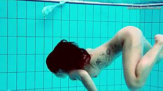 Nata the hot hungarian babe enjoys swimming in her bikini.