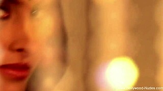 An asian brunette dances erotically, stripping and seducing with teasing moves, ripping clothes to reveal nude body in softcore scene.