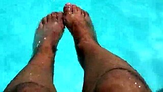 Feet splashing in the pool with lots of water