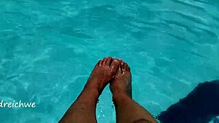 Feet splashing in the pool with lots of water