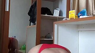 A sexy gay shemale in red crossdresser outfit and mask plays with toys and dildo in anal fun