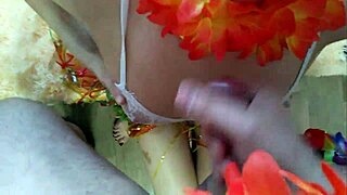 A couple shares intimate moments at a Hawaiian party.