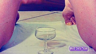 She pisses into glasses while her tits get wet