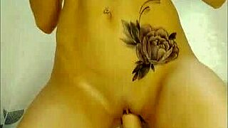 Cute shemale fucks her wet pussy with a big rubber dildo in the shower