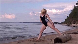 blonde woman bathing in the sea with a beautiful big ass in costume