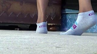 Ebony cougar shows puma socks and ass.