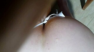 Latina pornstar masturbating intensely on wet sofa, cum dripping down her leg.