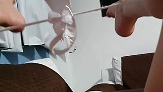 Latina pornstar masturbating intensely on wet sofa, cum dripping down her leg.