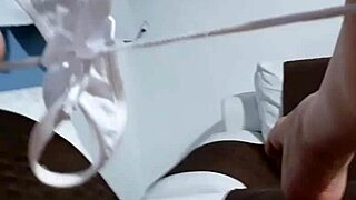 Latina pornstar masturbating intensely on wet sofa, cum dripping down her leg.