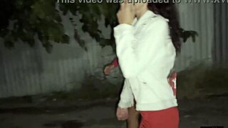 two girlfriends peeing together by the car in the public lot