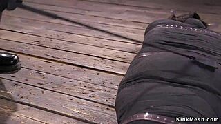 Mummified brunette gets whipped in rough bondage.