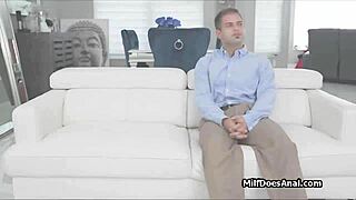 Busty milf enjoys butt plug while blowing dick in lingerie.