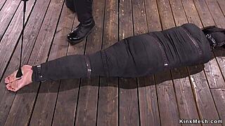 Mummified brunette gets whipped in rough bondage.