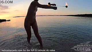 Hey, watch this pretty girl dance nude on the beach! 🔥