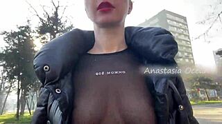 Blonde beauty flashes big boobs walking in public park.