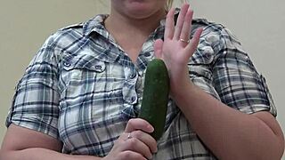 A fat girl with a hairy pussy masturbates with a cucumber