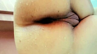 Queen masturbates in open-air bath before intense sex.